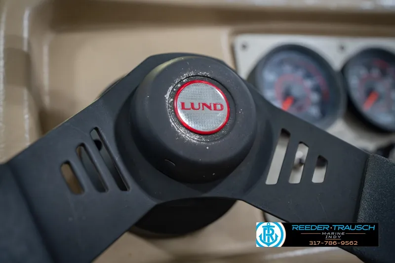 Slide: The Image of Steering wheel of 1997 Lund 1650 Angler SS boat with dashboard gauges in background. - 29