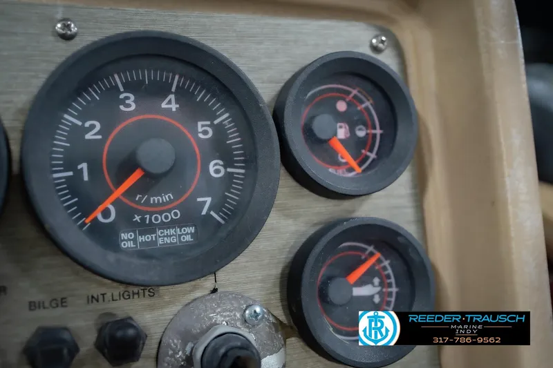 Slide: The Image of Dashboard gauges of a 1997 Lund 1650 Angler SS boat, featuring tachometer and fuel indicators. - 31
