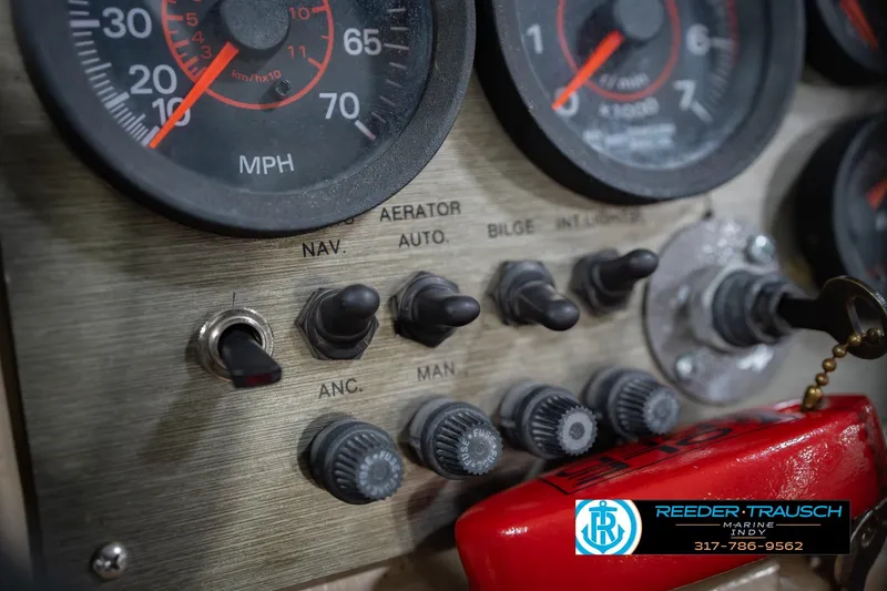 Slide: The Image of Dashboard controls of a 1997 Lund 1650 Angler SS boat with speedometer and switches. - 32