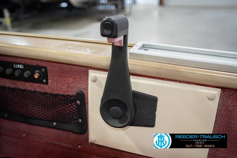Slide: The Image of 1997 Lund 1650 Angler SS boat interior with control lever and panel. - 34