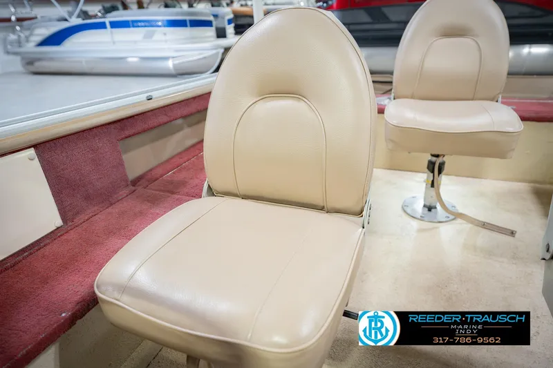 Slide: The Image of 1997 Lund 1650 Angler SS boat interior with beige seats and red carpet. - 35