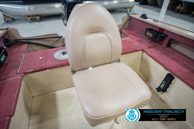 Slide: The Image of 1997 Lund 1650 Angler SS boat interior with beige seat and red carpet. - 36