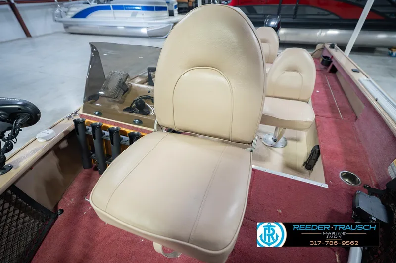 Slide: The Image of 1997 Lund 1650 Angler SS boat interior with beige seats and red carpet. - 37