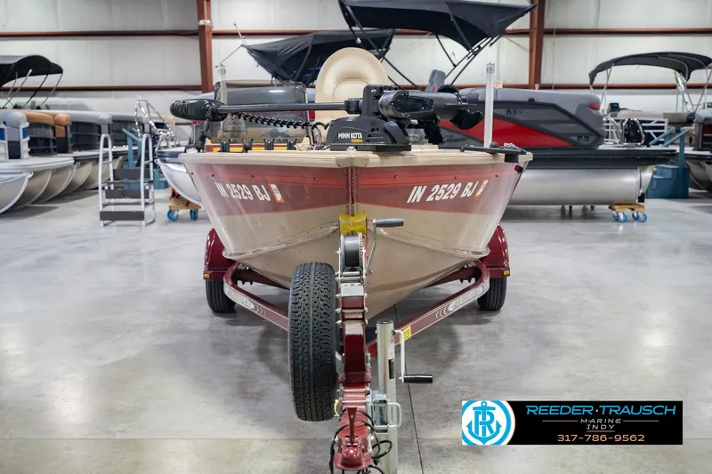 Slide: The Image of 1997 Lund 1650 Angler SS boat on trailer in showroom, featuring Minn Kota motor. - 4