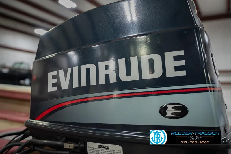 Slide: The Image of Evinrude outboard motor on a 1997 Lund 1650 Angler SS boat, indoor setting. - 43