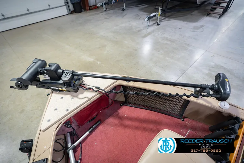 Slide: The Image of 1997 Lund 1650 Angler SS boat with Minn Kota trolling motor in a garage setting. - 46
