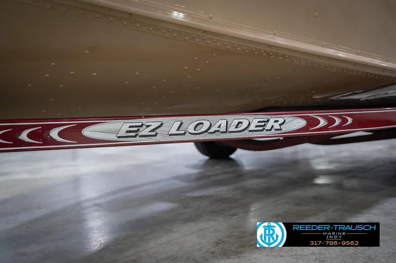 Slide: The Image of 1997 Lund 1650 Angler SS on EZ Loader trailer, Reeder Trausch Marine logo visible. - 53