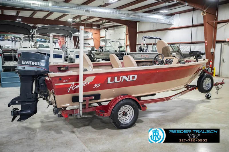 Slide: The Image of 1997 Lund 1650 Angler SS boat with Evinrude motor in showroom. - 7