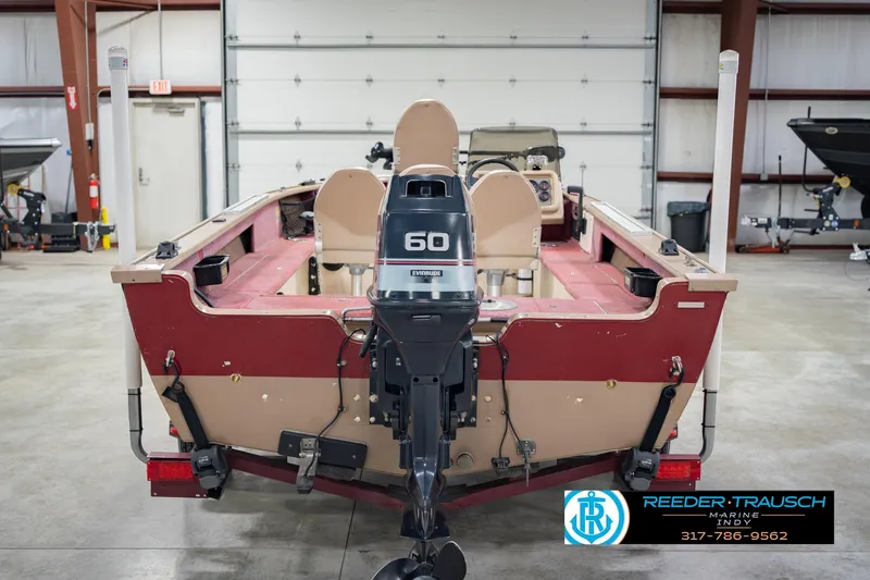 Slide: The Image of 1997 Lund 1650 Angler SS boat with Evinrude 60 motor in a garage setting. - 8