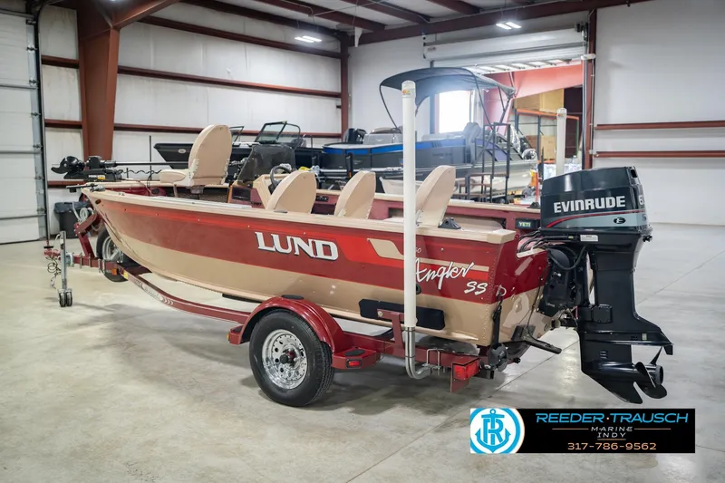 Slide: The Image of 1997 Lund 1650 Angler SS boat with Evinrude motor in a showroom. - 9