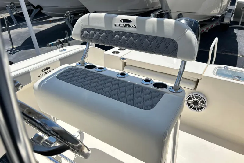 Slide: The Image of 2019 Cobia 220 Center Console boat interior with cushioned seating and cup holders. - 11