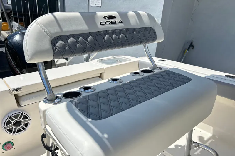 Slide: The Image of 2019 Cobia 220 Center Console boat seat with cup holders and stylish upholstery. - 12
