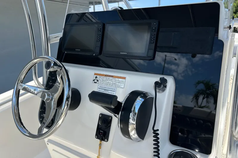 Slide: The Image of 2019 Cobia 220 Center Console dashboard with steering wheel and Garmin displays. - 14