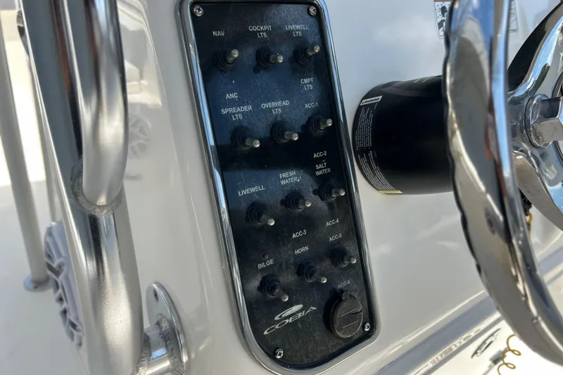 Slide: The Image of Control panel of a 2019 Cobia 220 Center Console boat with various switches. - 16