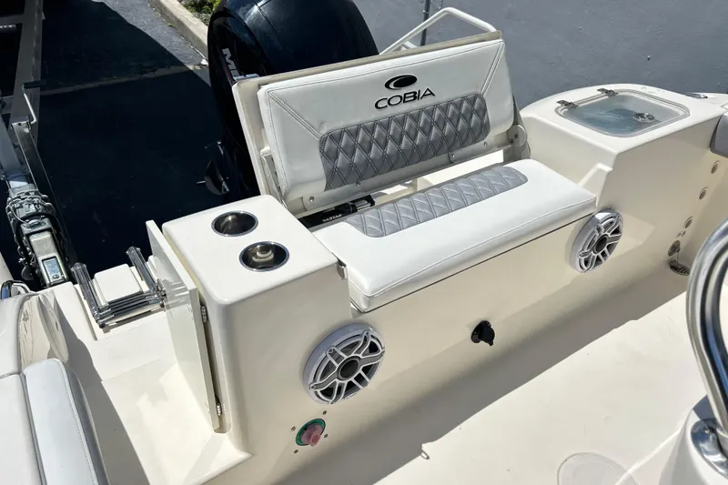 Slide: The Image of 2019 Cobia 220 Center Console boat interior with seating and cup holders. - 19