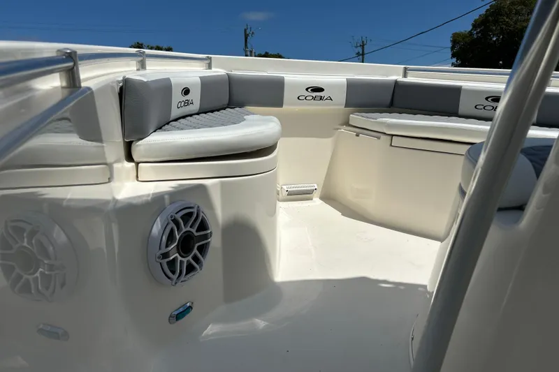 Slide: The Image of 2019 Cobia 220 Center Console boat interior with cushioned seating and speakers. - 2