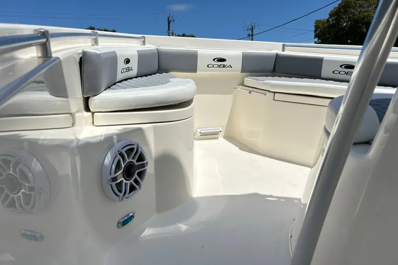 Slide: The Image of 2019 Cobia 220 Center Console boat interior with cushioned seating and speakers. - 3