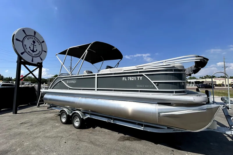 The Image of 2025 Godfrey Sweetwater 2286 SFL pontoon boat on trailer, displayed outdoors. - 0