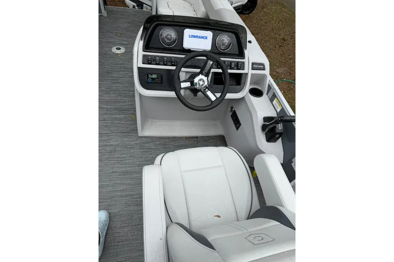Slide: The Image of 2025 Godfrey Sweetwater 2286 boat cockpit with steering wheel and control panel. - 10