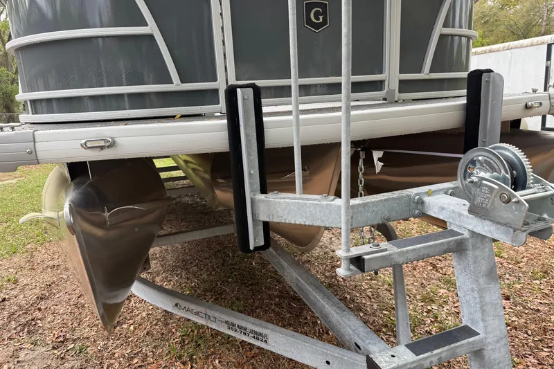 Slide: The Image of 2025 Godfrey Sweetwater 2286 pontoon boat on trailer, close-up view. - 13