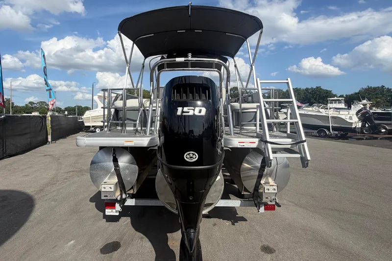 Slide: The Image of 2025 Godfrey Sweetwater 2286 SFL pontoon boat with 150 HP engine, parked outdoors. - 4