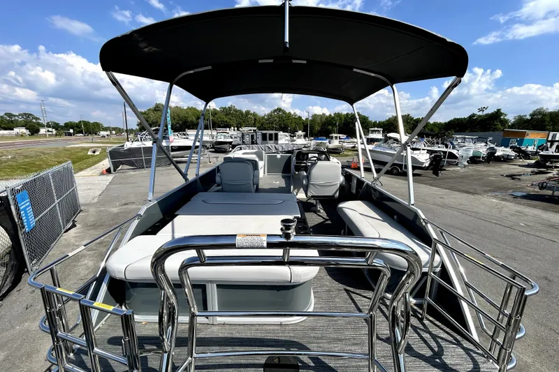 Slide: The Image of 2025 Godfrey Sweetwater 2286 SFL pontoon boat interior with seating and outboard motor. - 31