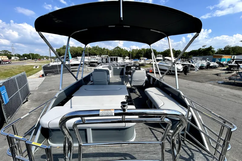Slide: The Image of 2025 Godfrey Sweetwater 2286 SFL pontoon boat interior with seating and sunny outdoor view. - 32