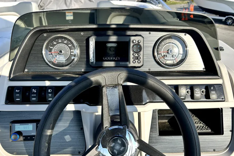 Slide: The Image of 2025 Godfrey Sweetwater 2286 SFL pontoon boat interior with seating and motor view. - 34