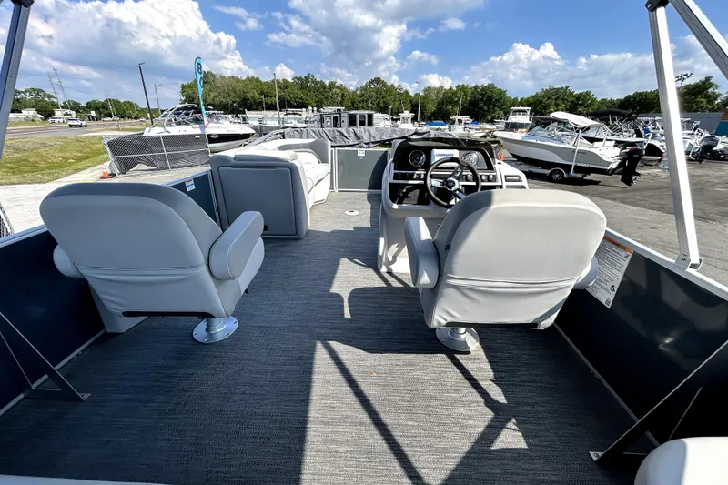 Slide: The Image of 2025 Godfrey Sweetwater 2286 SFL pontoon boat with Suzuki outboard motor, parked outdoors. - 36