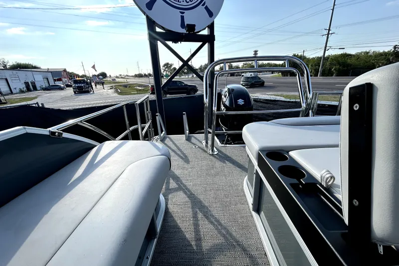 Slide: The Image of 2025 Godfrey Sweetwater 2286 SFL boat with Suzuki outboard motor, docked on a sunny day. - 39