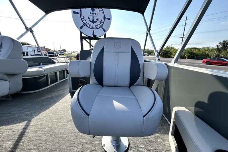 Slide: The Image of 2025 Godfrey Sweetwater 2286 SFL boat with Suzuki outboard motor, docked on concrete. - 40