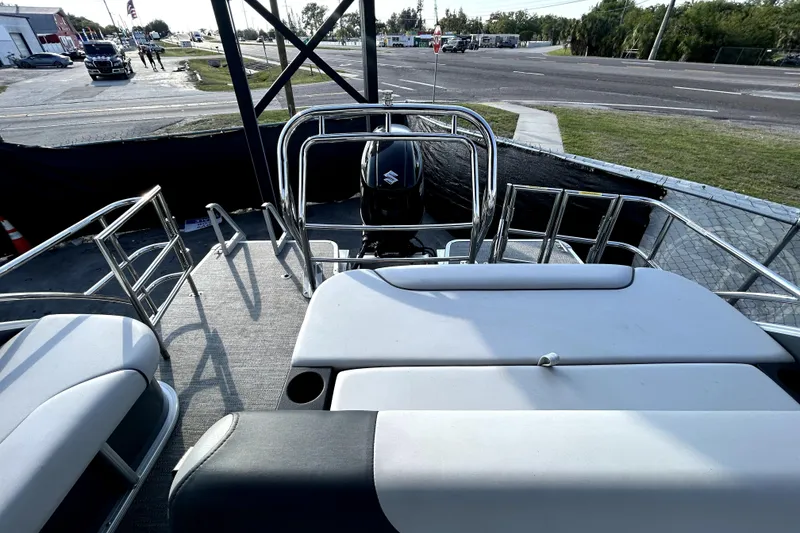 Slide: The Image of 2025 Godfrey Sweetwater 2286 SFL pontoon boat with canopy, parked in a marina. - 41
