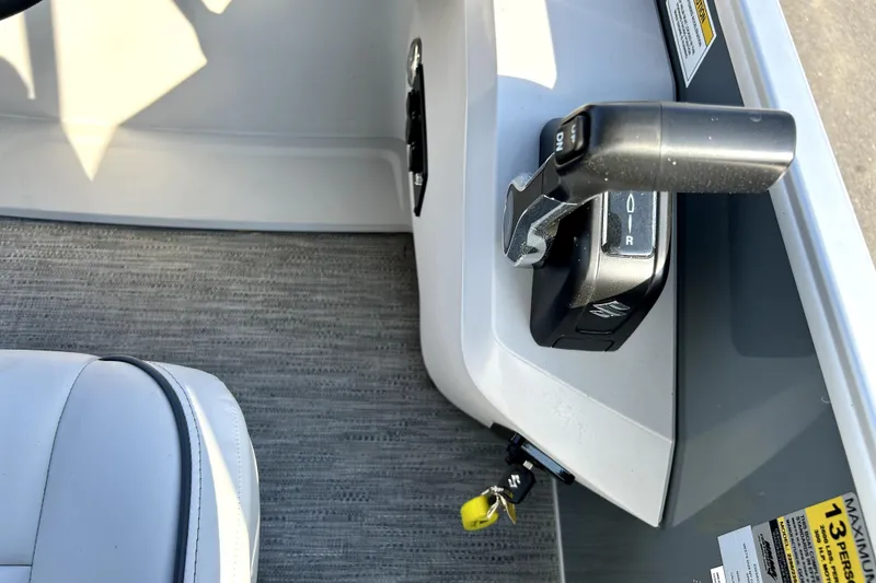 Slide: The Image of 2025 Godfrey Sweetwater 2286 SFL pontoon boat with spacious seating and canopy in a marina. - 47