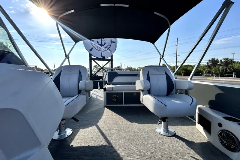 Slide: The Image of 2025 Godfrey Sweetwater 2286 SFL pontoon boat interior with seating and steering console. - 48