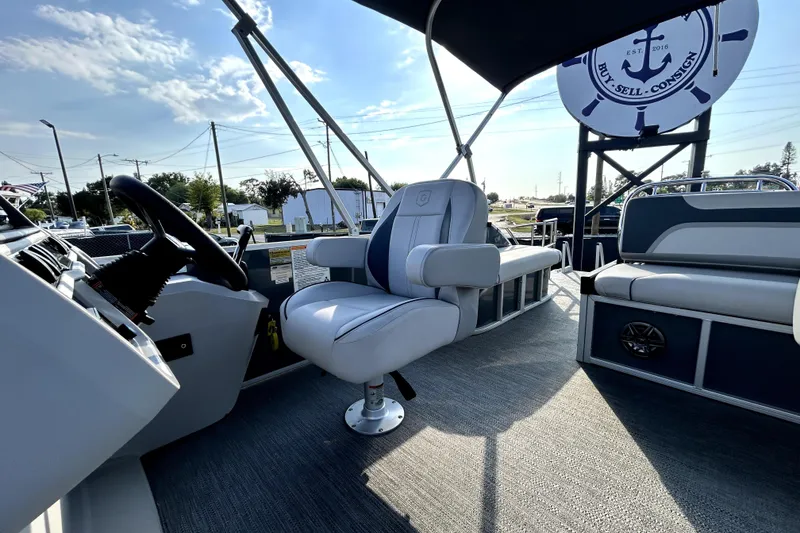 Slide: The Image of Interior view of 2025 Godfrey Sweetwater 2286 SFL pontoon boat with modern seating and steering console. - 49