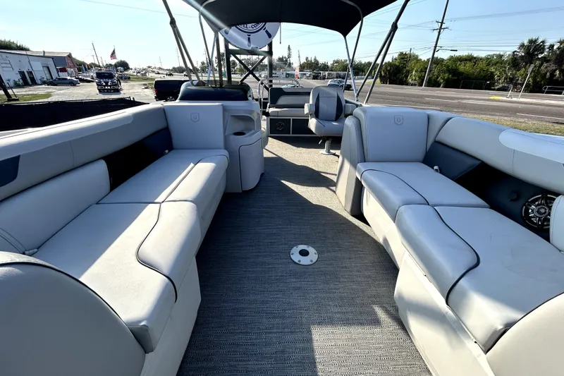 Slide: The Image of 2025 Godfrey Sweetwater 2286 SFL pontoon boat interior with steering console and seating. - 51