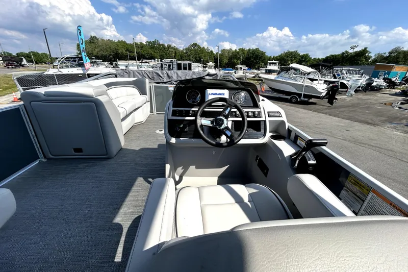 Slide: The Image of 2025 Godfrey Sweetwater 2286 SFL pontoon boat interior with steering console and seating. - 54
