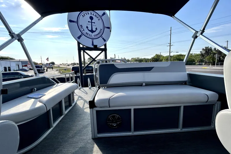 Slide: The Image of 2025 Godfrey Sweetwater 2286 SFL boat dashboard with steering wheel and control panel. - 57