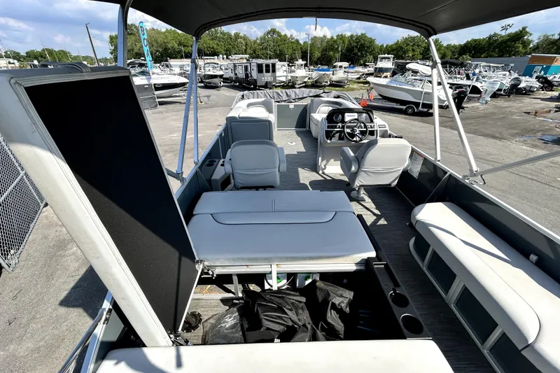 Slide: The Image of Dashboard controls of 2025 Godfrey Sweetwater 2286 SFL boat with speedometer and radio display. - 59