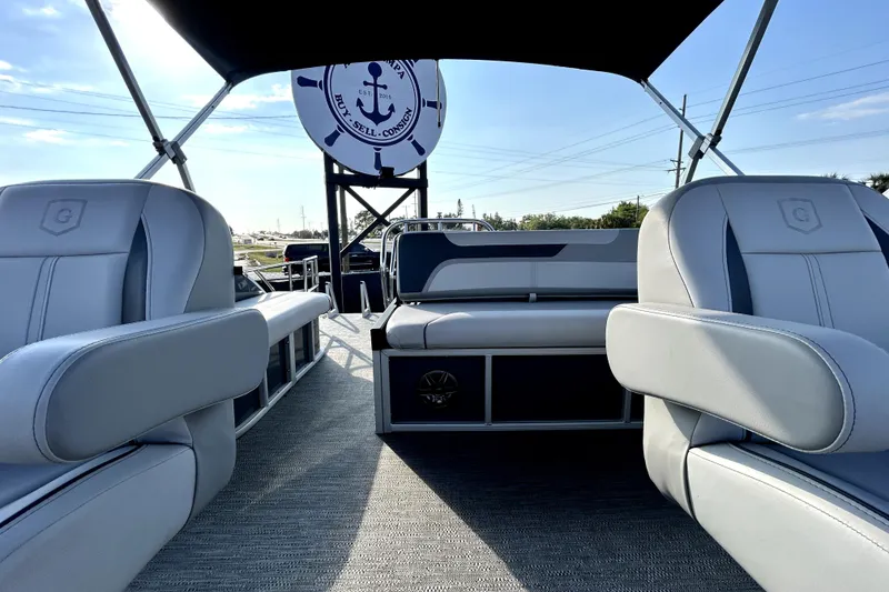 Slide: The Image of 2025 Godfrey Sweetwater 2286 SFL pontoon boat interior with plush seating and modern dashboard. - 66