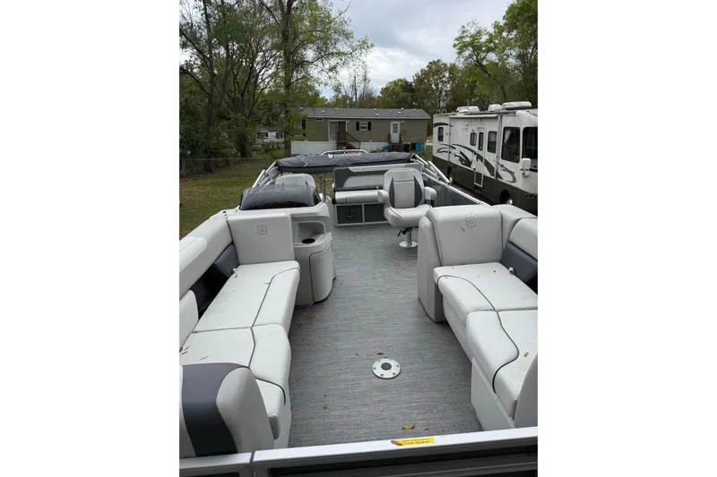 Slide: The Image of 2025 Godfrey Sweetwater 2286 pontoon boat with spacious seating and modern design. - 7