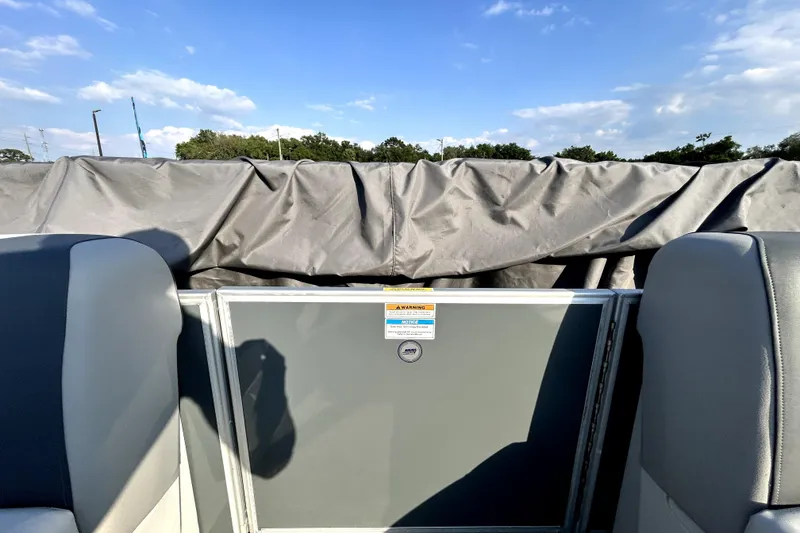 Slide: The Image of 2025 Godfrey Sweetwater 2286 SFL boat interior with gray seating and covered deck. - 72