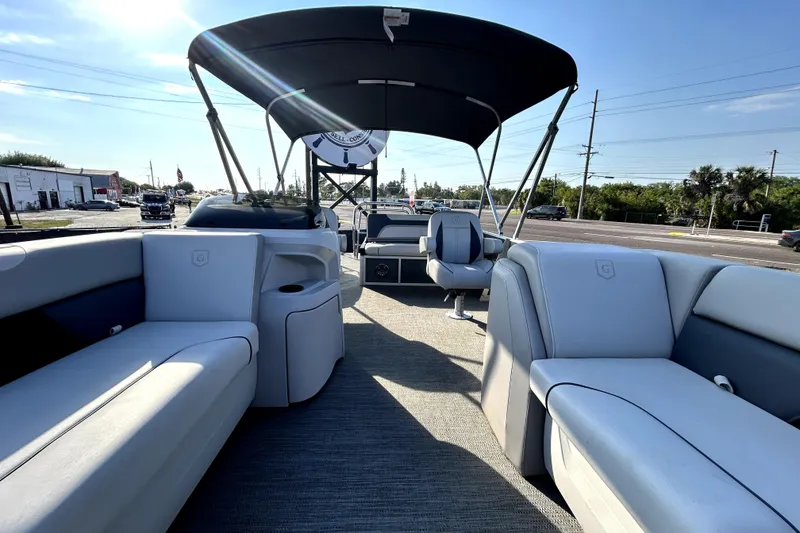 Slide: The Image of 2025 Godfrey Sweetwater 2286 SFL pontoon boat interior at a marina. - 77