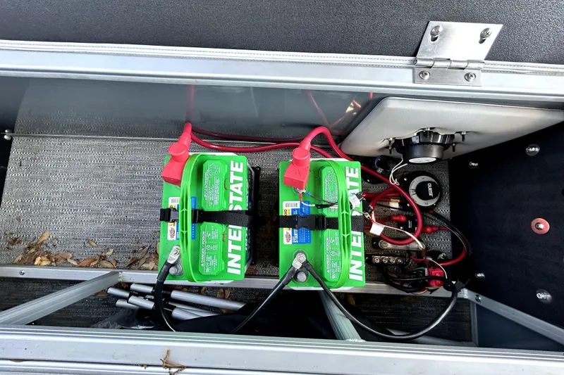 Slide: The Image of Battery compartment of 2025 Godfrey Sweetwater 2286 SFL with Interstate batteries and wiring. - 79