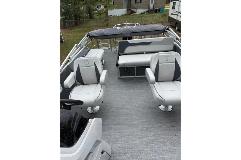 Slide: The Image of 2025 Godfrey Sweetwater 2286 pontoon boat interior with gray seating and carpet. - 8