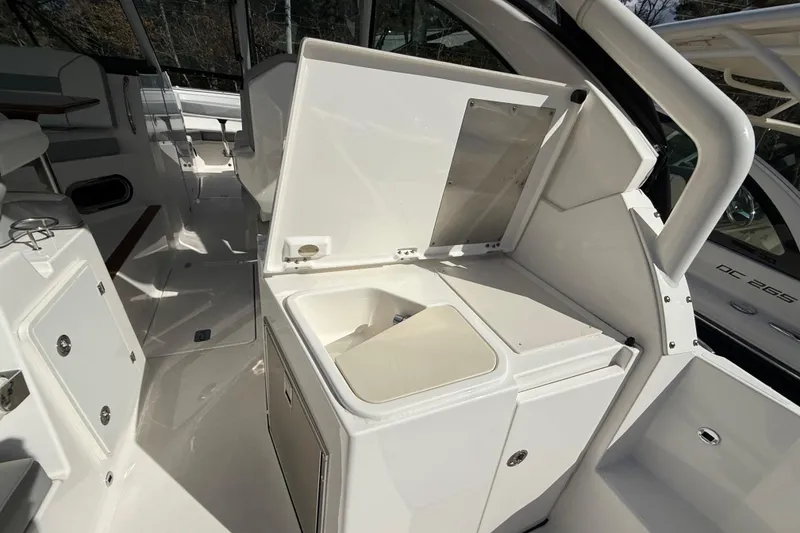 Slide: The Image of 2022 Pursuit DC 326 Dual Console boat interior with open storage compartment. - 10