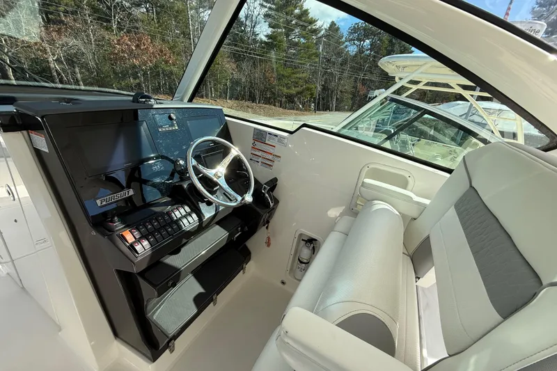 Slide: The Image of 2022 Pursuit DC 326 Dual Console helm with modern controls and comfortable seating. - 13