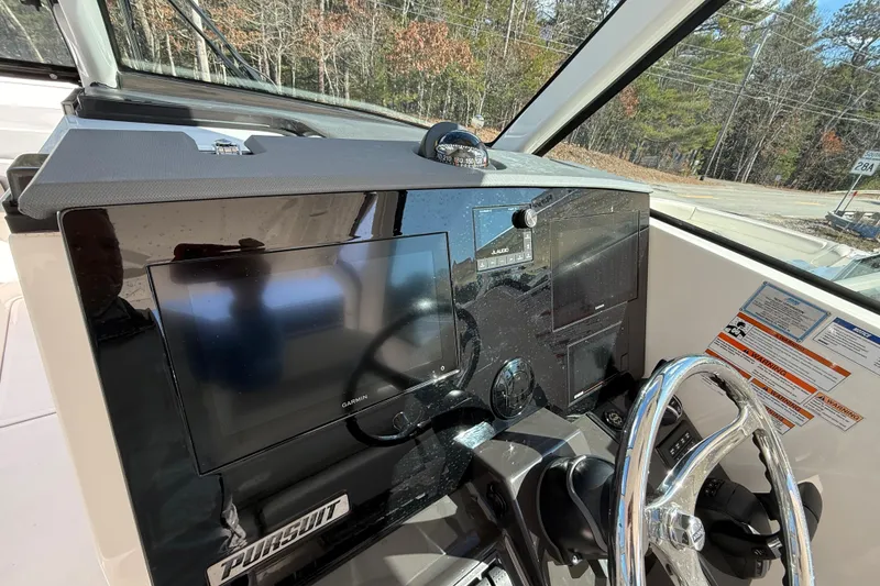 Slide: The Image of 2022 Pursuit DC 326 Dual Console dashboard with Garmin display and steering wheel. - 14
