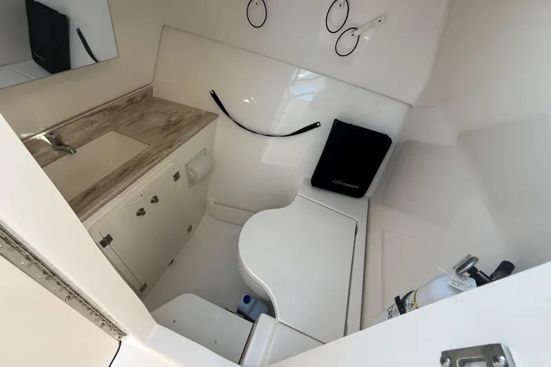 Slide: The Image of 2022 Pursuit DC 326 Dual Console boat interior with sink and storage. - 18