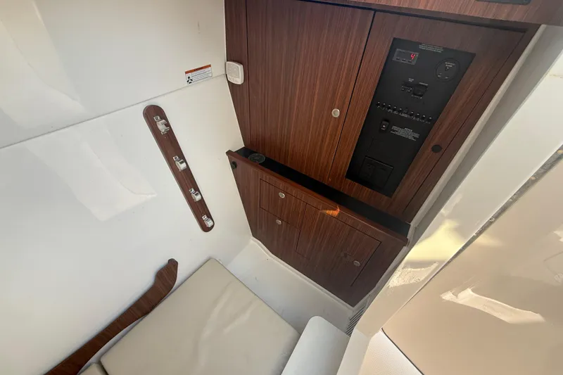 Slide: The Image of 2022 Pursuit DC 326 Dual Console interior with wood paneling and control panel. - 19